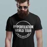 Man in a black t-shirt featuring "Hyperfixation World Tour" design, perfect for neurodivergent fashion lovers.