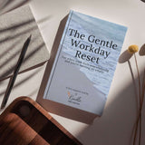 The Gentle Workday Reset ebook cover on a desk, promoting a free toolkit for stress relief and workday pauses.
