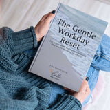 Person holding "The Gentle Workday Reset" ebook, designed for moments of overwhelm and reflection during workdays.