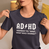 Person wearing a navy t-shirt with humorous ADHD graphic and text.
