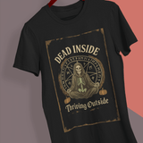 Black t-shirt with skeleton design and text on a hanger against a gray background