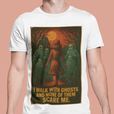 White t-shirt with a graphic design of a woman walking with ghosts and text on a peach background