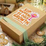 Colorful sticker on a gift box reading 'Sip Happens, So Does Growth' surrounded by festive decor.