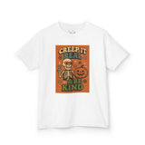 Kids Halloween tee featuring skeleton design with text 'Creep It Real & Be Kind' on a white backdrop.