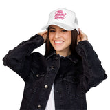 Fun summer Foam Trucker Hat with 'Too Much Good' design, stylishly worn by a smiling woman in casual denim.