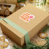 Gift box with 'Sip Happens, So Does Growth' sticker, surrounded by festive decor and greenery.