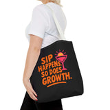 Black tote bag featuring vibrant text 'Sip Happens. So Does Growth.' with a colorful cocktail graphic.