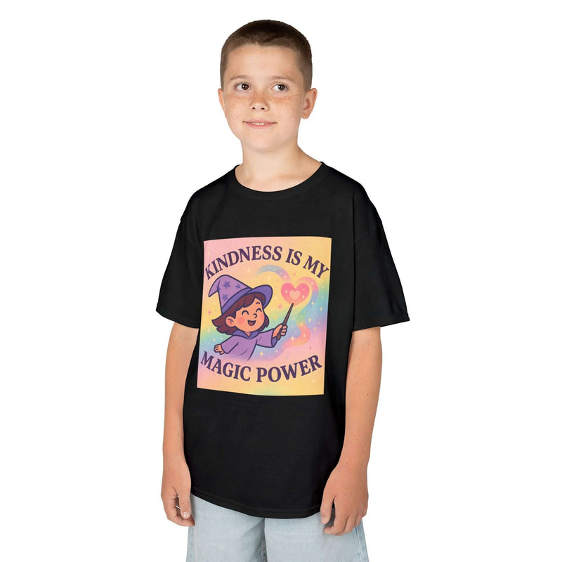 Smiling boy wearing a black Kids Magical Kindness Tee with 'Kindness is My Magic Power' design.
