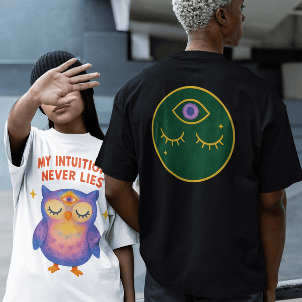 Two people wearing t-shirts with unique designs, one featuring an owl and the other a green circle with an eye symbol.