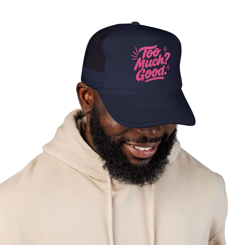 Man smiling in a trendy navy Foam Trucker Hat with 'Too Much Good' embroidered design, perfect for casual summer outings.