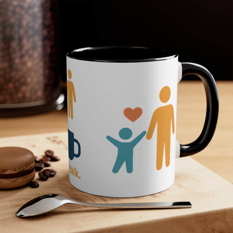 Mug with social icons on a wooden surface with coffee beans and a macaron.