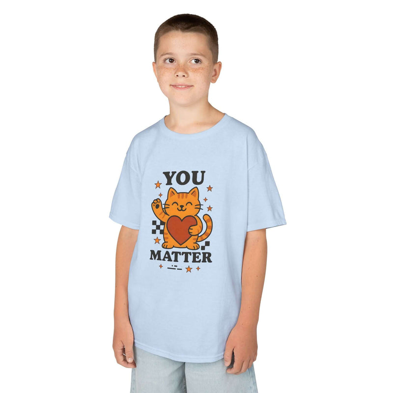 Child wearing a light blue tee with a cartoon cat and the message 'YOU MATTER', promoting positivity and self-love.
