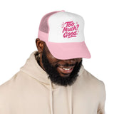 Man wearing a pink and white Too Much Good trucker hat, showcasing a fun and trendy summer style.