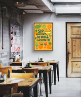 Inspirational wall art print featuring "Sip Happens. So Does Growth" in a café setting with fruity designs.