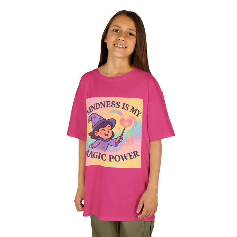 Smiling girl wearing pink Kids Magical Kindness Tee with whimsical design about kindness and magic.