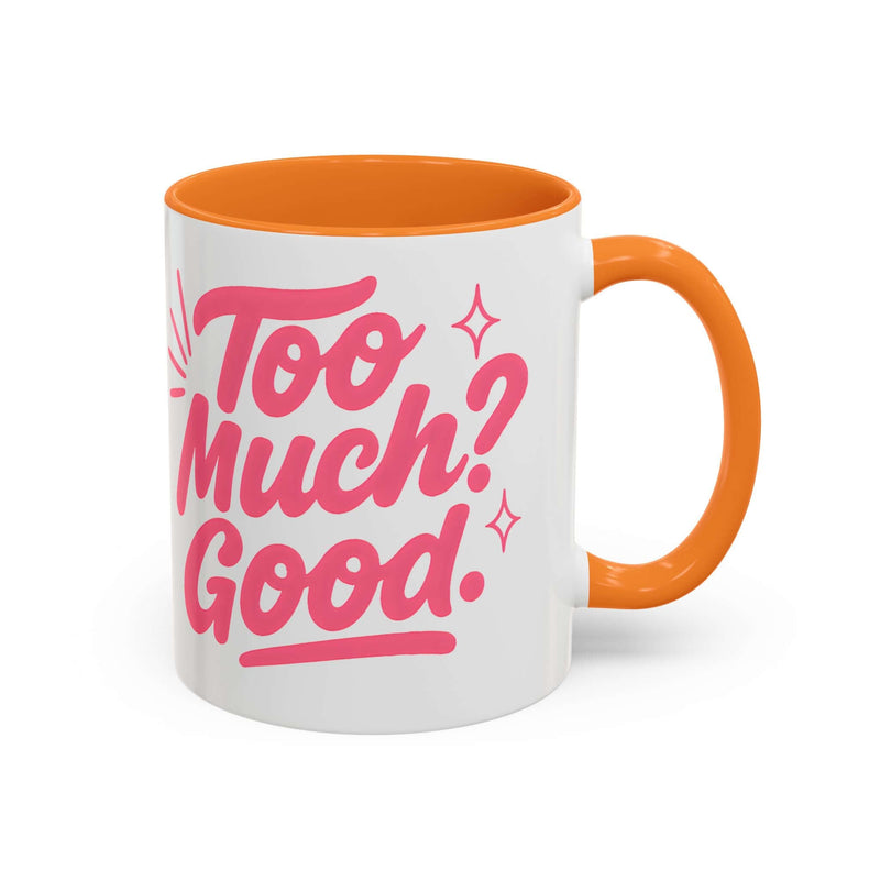Colorful coffee mug with pink text "Too Much? Good." and orange handle, perfect for bright mornings and gifts.