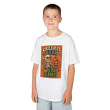Kid wearing a Halloween tee featuring skeleton and pumpkin design with 'Creep It Real & Be Kind' slogan.