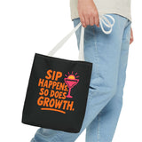 Black cotton tote bag with 'Sip Happens, So Does Growth' graphic, ideal for beach or grocery shopping.