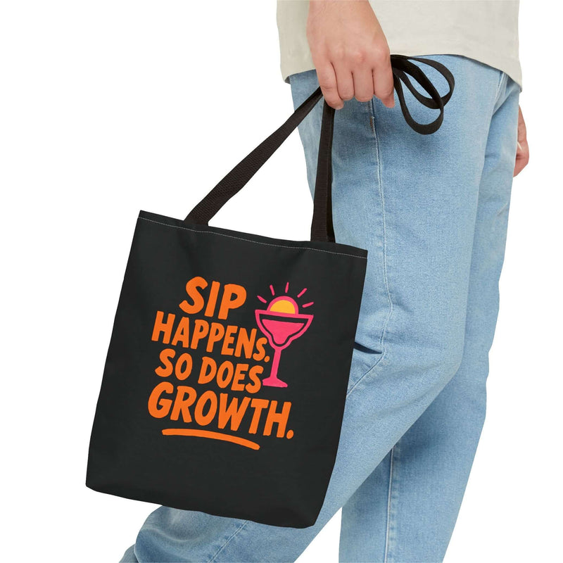Black cotton tote bag with 'Sip Happens, So Does Growth' design, perfect for beach, grocery, and eco-friendly use.