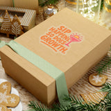 Wooden gift box with 'Sip Happens So Does Growth' sticker, decorated with greenery and festive ornaments.