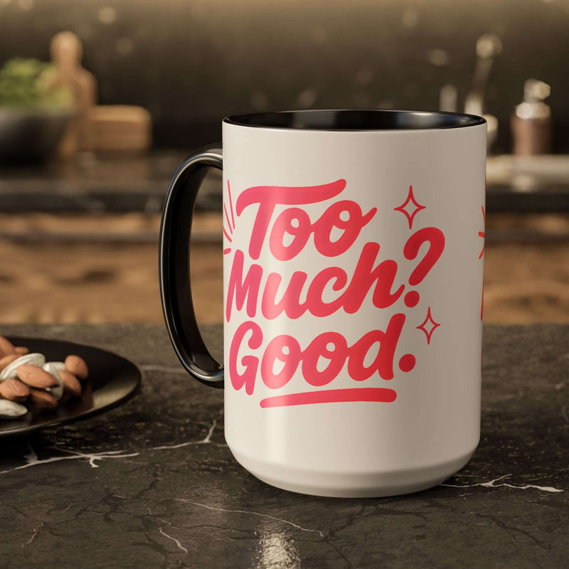 Colorful affirmation mug with the phrase 'Too Much? Good.' on a black and white design, perfect for coffee lovers.