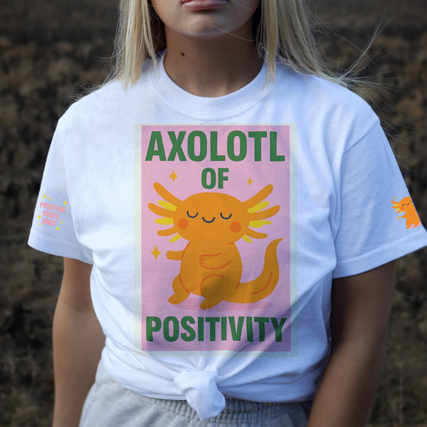 Person wearing a white t-shirt with an axolotl graphic and text outdoors.