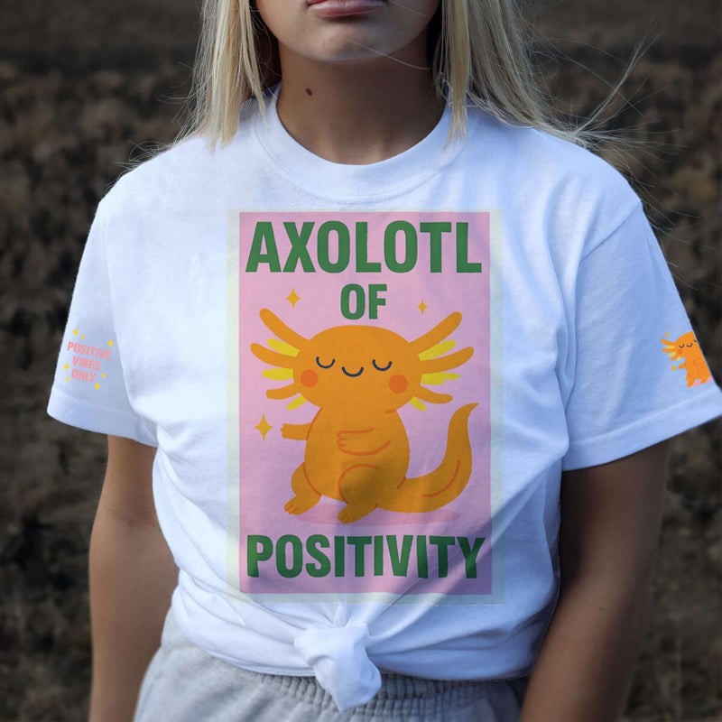 Person wearing a white t-shirt with an axolotl graphic and text outdoors.