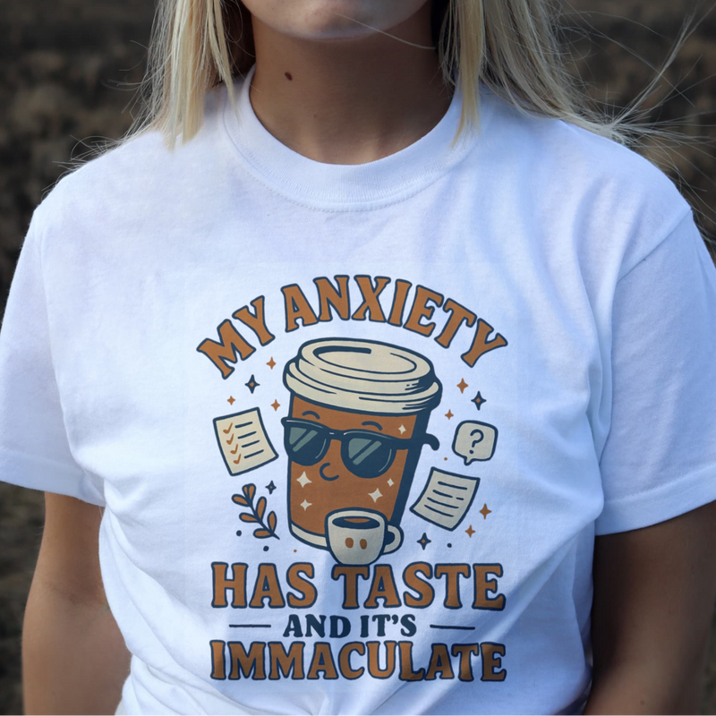 Person wearing a white t-shirt with a graphic design and text.