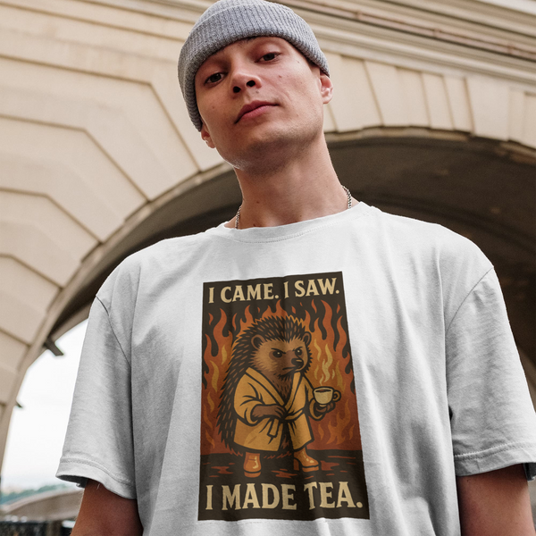 Person wearing a t-shirt with a graphic design of a lion and text, standing in front of an architectural background.