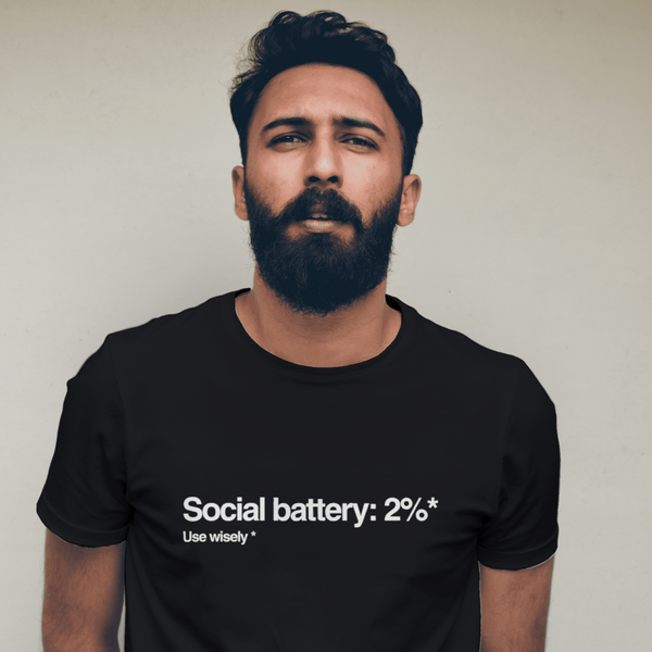 Man wearing a black t-shirt with text against a plain background