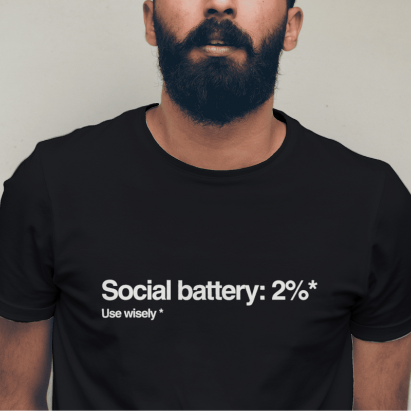 Man wearing a black t-shirt with text against a plain background