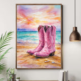 Framed painting of pink cowboy boots on a beach with a wooden cabinet and plant in the foreground.