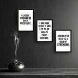 Three motivational wall art prints with empowering quotes for men in a stylish black frame setting.