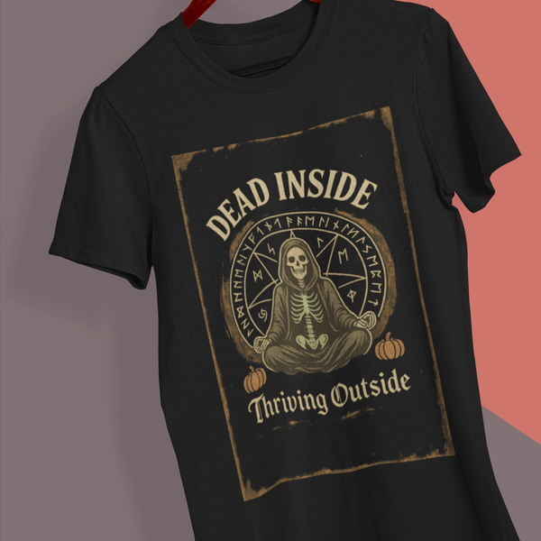 Black t-shirt with skeleton design and text on a hanger against a gray background