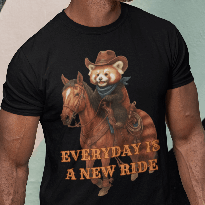 Man wearing a black t-shirt with a graphic of a bear riding a horse and text 'Everyday is a New Ride' against a colorful background.