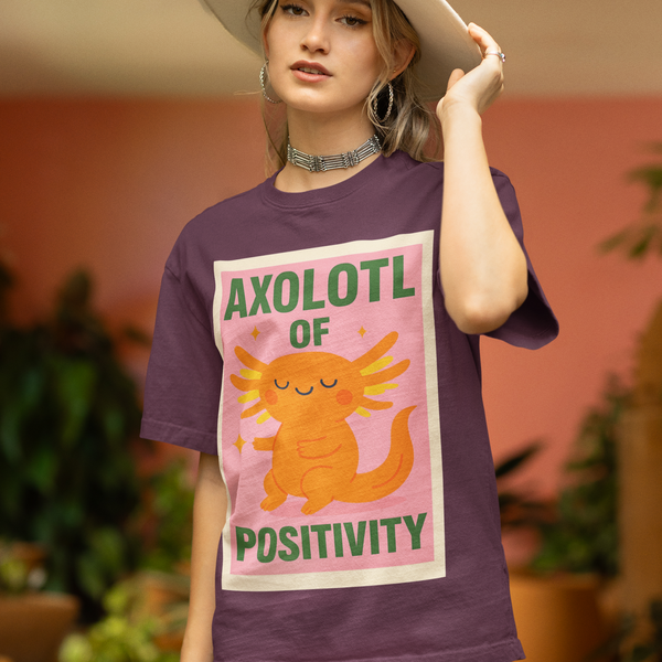 Person wearing a purple t-shirt with an axolotl graphic and text in a casual setting.